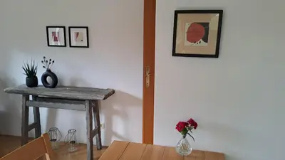 a dining room with a table and a vase of flowers at FLAT FOR 2 - Alpine Dream Bled in Bled