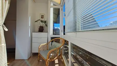 a wicker chair sitting in a room with a window at FLAT FOR 2 - Alpine Dream Bled in Bled