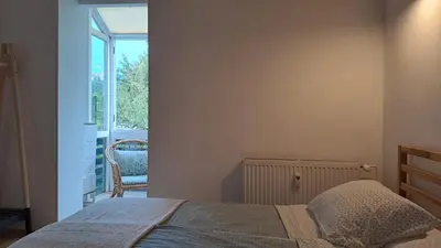 a bedroom with a bed and a window and a chair at FLAT FOR 2 - Alpine Dream Bled in Bled