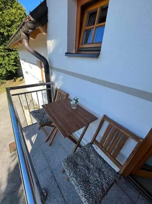 a table and two chairs next to a building at Villa VINEYARD in Velika Nedelja