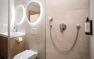 a bathroom with a shower with a toilet and a sink at M16 Apartments in Ljubljana