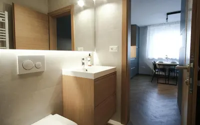 a bathroom with a sink and a toilet and a table at M16 Apartments in Ljubljana