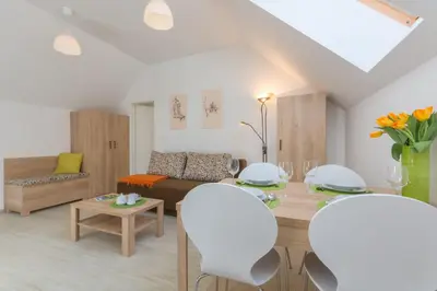 a living room with a table and a couch at Old Town first floor in Ljubljana