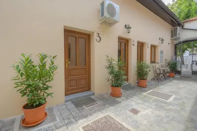 a building with potted plants in front of a door at Old Town first floor in Ljubljana