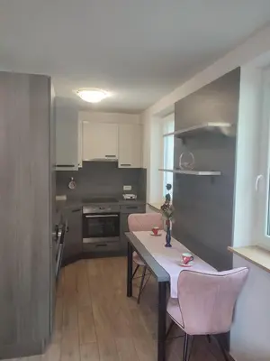 a kitchen with a table and chairs in a room at Počitniško stanovanje Aurora in Bovec