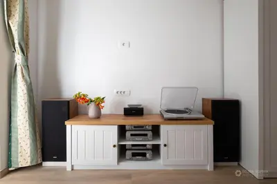 a table with a laptop and two speakers at Cherry house - cosy house - ideal for bear watching, in the neighborhood of the medieval Snežnik castle in Stari Trg pri Ložu