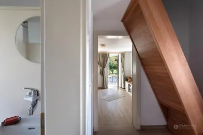 a hallway with a stairway leading into a house at Cherry house - cosy house - ideal for bear watching, in the neighborhood of the medieval Snežnik castle in Stari Trg pri Ložu