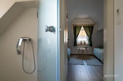 a bathroom with a shower and a bedroom at Cherry house - cosy house - ideal for bear watching, in the neighborhood of the medieval Snežnik castle in Stari Trg pri Ložu