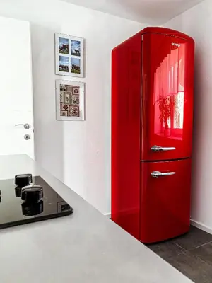 a red refrigerator in a kitchen next to a counter at The View 22 in Cerklje na Gorenjskem