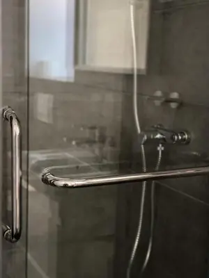 a shower with a glass door with a faucet at The View 22 in Cerklje na Gorenjskem
