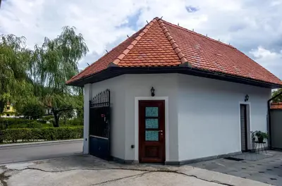 a small white building with a red roof at Riverside studio 1 in Ljubljana