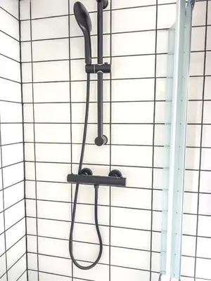a shower head hanging on a wall at Riverside studio 1 in Ljubljana