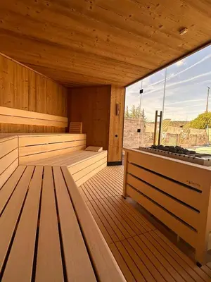 a sauna with wooden floors and a large window at Apartments Kras 24 with Pool in Sežana