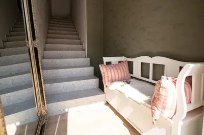 a room with two beds and a staircase at Apartments Kras 24 with Pool in Sežana