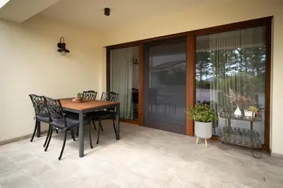 a dining room table and chairs on a patio at Apartments Kras 24 with Pool in Sežana