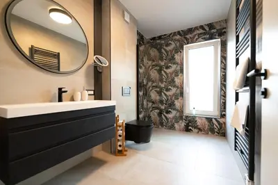 a bathroom with a sink and a mirror at Apartments Kras 24 with Pool in Sežana