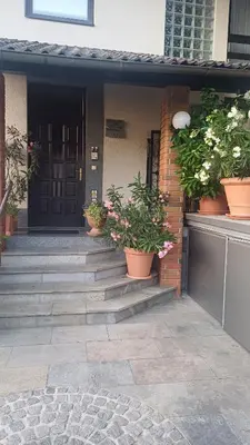 a front door of a house with potted plants at Apartma AJDA in Velenje