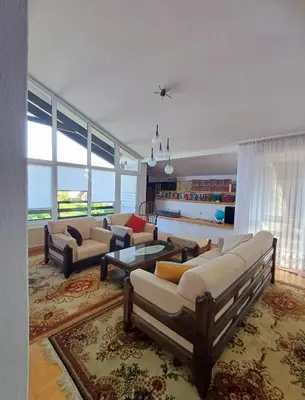 a large living room with couches and a table at Apartma AJDA in Velenje