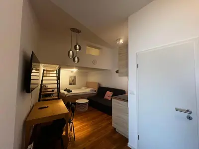 a small apartment with a desk and a living room at Ljubljana Studios in Ljubljana