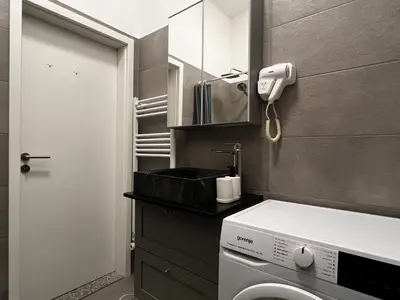 a small bathroom with a toilet and a sink at Ljubljana Studios in Ljubljana