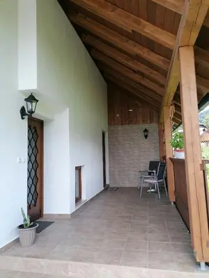 a patio with a wooden ceiling and a table and chairs at Apartments at Klemen in Zgornje Gorje