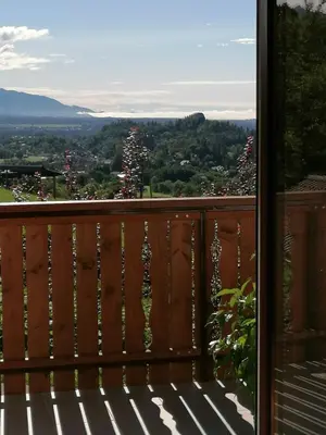 a bench on a balcony with a view at Apartments at Klemen in Zgornje Gorje