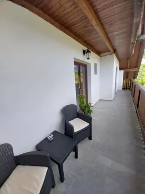 a patio with two chairs and a table at Apartments at Klemen in Zgornje Gorje