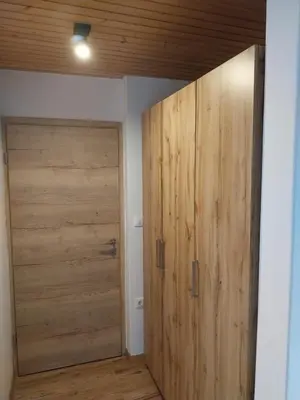 a large wooden door in a room with a room at Apartments at Klemen in Zgornje Gorje