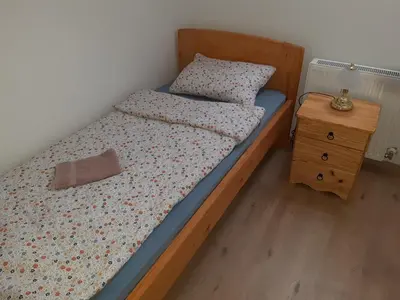 a bedroom with a bed and a night stand at Hisa jager in Gradišče v Slovenskih Goricah