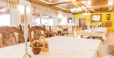 a dining room with a table and chairs and a table sidx sidx at Nature Hotel Lukanc in Bled