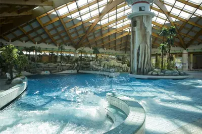 a large indoor swimming pool in a building at Happy Camp Mobile Homes in Camping Terme Čatež in Čatež ob Savi