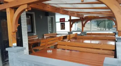 a row of benches in a church with an arch at Hotel and Restaurant Ana in Hrib-Loški Potok