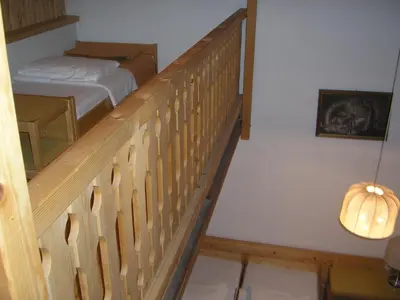 a staircase leading to a bedroom with a bed at Camping Pivka Jama Postojna in Postojna