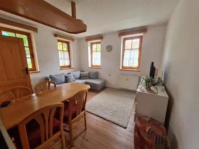 a living room with a table and a couch at Apartment Moravske Toplice in Moravske Toplice