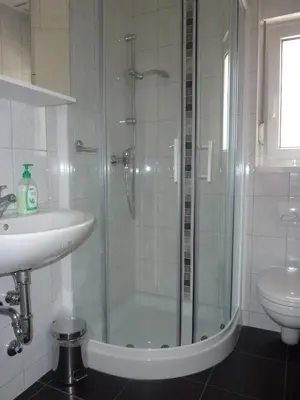 a bathroom with a shower and a sink at Rooms Mira G in Postojna