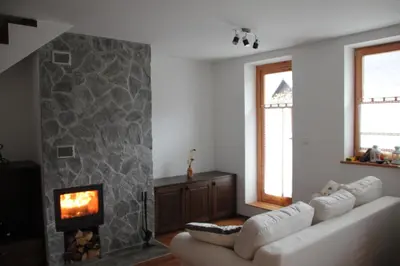 a living room with a couch and a fireplace at Apartment MT Čezsoča in Bovec