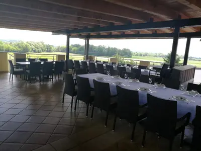 a dining room with white tables and chairs at Gostilna in prenočišče KOCJAN in Bizeljsko