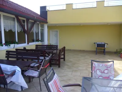 a patio with tables and chairs in a building at Gostilna in prenočišče KOCJAN in Bizeljsko