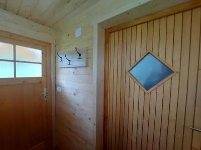 a wooden paneled room with a door and a window at Apartma Markelj in Radovljica