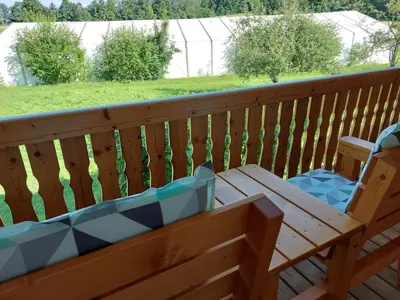 a wooden bench sitting on a wooden deck at Apartma Markelj in Radovljica