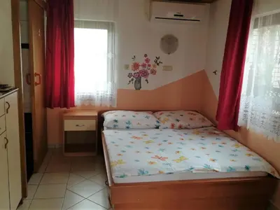 a small bedroom with a bed and a window at TURIZEM GRABRIJAN, Jasmina Grabrijan s.p. in Adlešiči