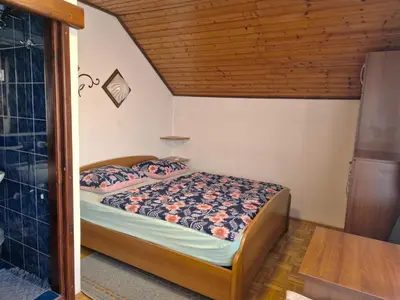 a bedroom with a bed in a small room at TURIZEM GRABRIJAN, Jasmina Grabrijan s.p. in Adlešiči
