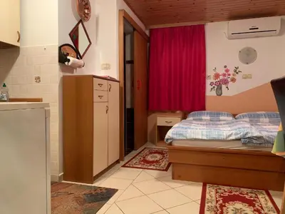 a bedroom with a bed and a red curtain at TURIZEM GRABRIJAN, Jasmina Grabrijan s.p. in Adlešiči