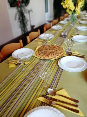 a long table with glasses and a pizza on it at TURIZEM GRABRIJAN, Jasmina Grabrijan s.p. in Adlešiči