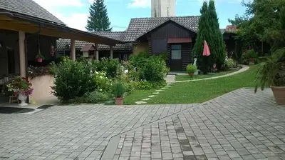 a house with a brick driveway in front of a yard at TURIZEM GRABRIJAN, Jasmina Grabrijan s.p. in Adlešiči