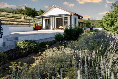 a house with a garden in front of it at Sunny Hill in Vremski Britof