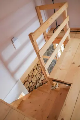 an overhead view of a wooden stairs with a pile of logs at ABC Apartma Kočevsko in Kočevje