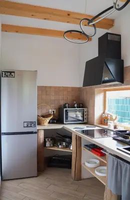 a kitchen with a refrigerator and a counter top at ABC Apartma Kočevsko in Kočevje