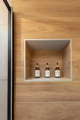 three bottles of whiskey in a wooden cabinet at Naša hiša in Bohinj