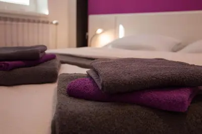 a pile of towels sitting on top of a bed at Naša hiša in Bohinj